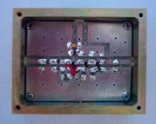 [Photograph of PCB mounted in box]